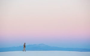 A man walking across the desert
