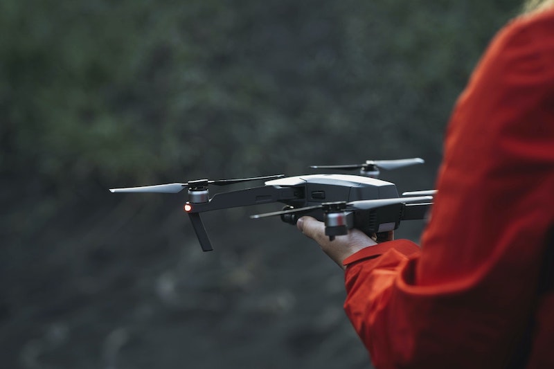 photographer launching a drone from hand