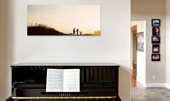 family photo over a piano on the wall