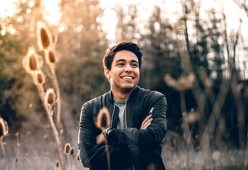 man in photoshoot standing in field